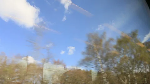 View from a train window trees and blue sky Stock Footage 37223753