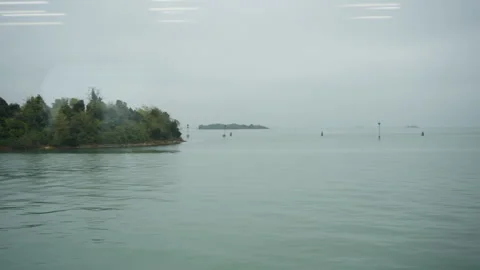 View from Train Window of Venetian Lagoon and Island with Boat in Italy Video stock 325721449