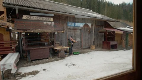 View from a train window as a violinist plays at Mocanita station in winter Stock Footage 346718126