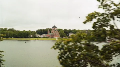 View from the train window. You can see the pond and the church Stock Footage 84883938