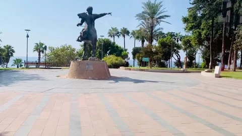 View from the tram in antalya of statue pointing towards palm trees Stock Footage 139103180