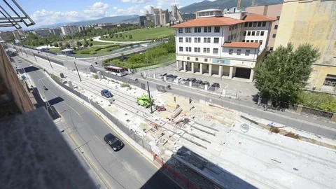 View of tramway constuction site with car traffic, park and modern building Stock Footage 75934923