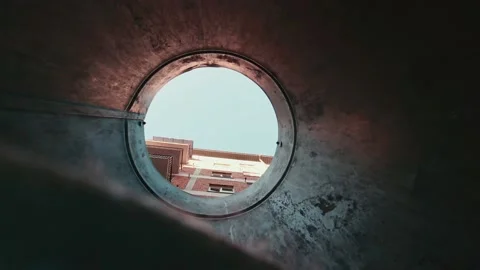 View up from trash bin bottom to face mask falling down released by mans hand Stock Footage 147351505