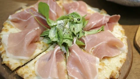 View of a tray of pizza with full of parma ham Stock Footage 202127382