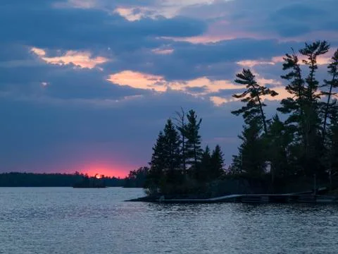 View of trees at lakeside during sunset, Lake of The Woods, Ontario, Canada 스톡 사진