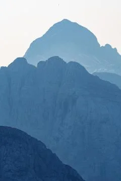 View of Triglav through layers of mountain peaks in Alps Stock Photos