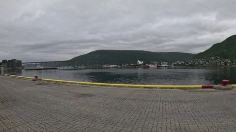 View of Tromso Bridge Arctic Cathedral and fjord from paved pier Norway Vidéo 341697352