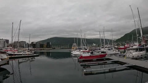 View of Tromso marina harbor basin with yachts and water reflections Norway Видео 341697387