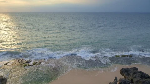 View of a tropical beach from cliff with huge waves are hitting rock Stock Footage 114989403
