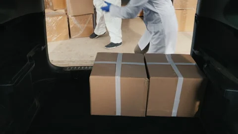 View from the trunk of the car - loading boxes with medicines Stock Footage 146320911