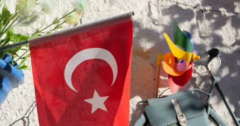 A view of the Turkish flag in the foreground and a children's spinner with LGBTQ Stock Footage 229618225
