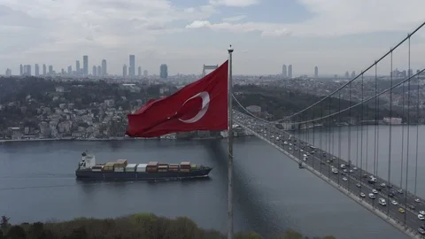 View of Turkish Flag over the Bosphorus and 15 July Martyrs Bridge in Istanbul Stock Footage 109414045