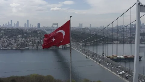 View of Turkish Flag over the Bosphorus and 15 July Martyrs Bridge in Istanbul Stock Footage 109420660