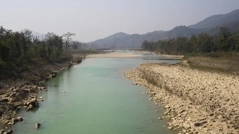 View of a turquoise river flowing through a lush valley, Nepal. 動画素材 335604017