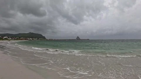 View of turquoise waves on Bleik beach with distant people walking in Norway Stock-Footage 343130579