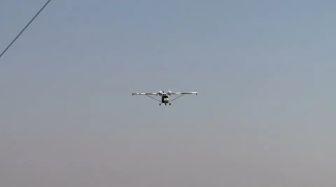 View of twin-engine plane flies over windsock Stock Footage 57640890