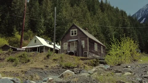 The view of two abandoned houses in the ghost town of Sandon, BC Stock Footage 282124000