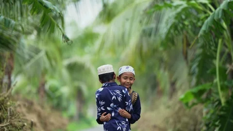 View of two boys hugging in a tropical setting, Bangladesh. Video stock 334991540