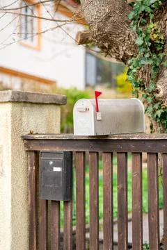 View of two different mailboxes installed on the fence of a private house Stock Photos