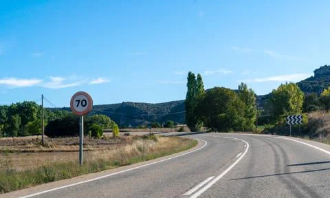 View of Two Direction Road in Spain With Speed Sign Stock Photos