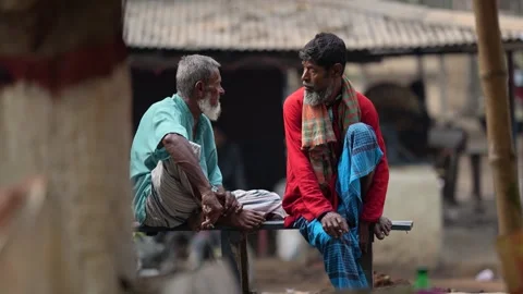 View of two elderly men sitting in a village, Bangladesh. Video stock 335554755