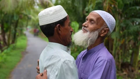View of two elderly Muslim men greeting on a rural road, Bangladesh. Video stock 334991982