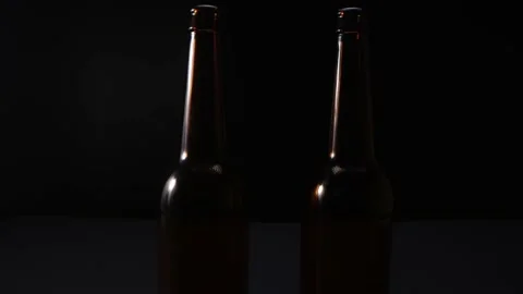 View of two glass bottles on dark background 動画素材 169872662