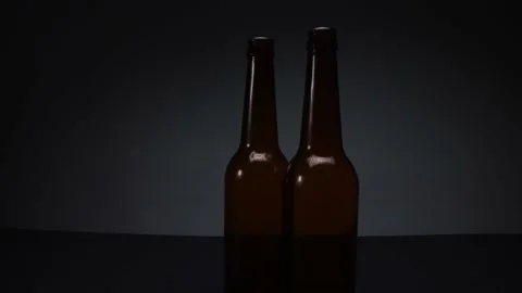 View of two glass bottles on dark background Stock Footage 169872688