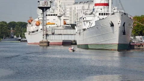View of Two large white ships and a submarine at the city pier. Summer Day Video stock 84656571