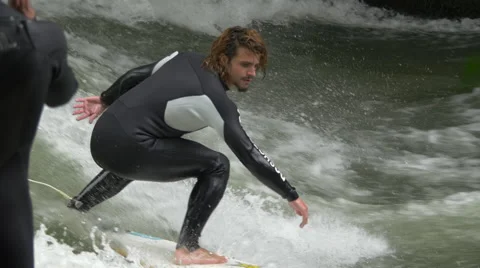 View of two men surfing on Isar River in Munich Stock Footage 54546244