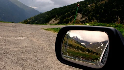 View of two mountains, one of them seen through the rear view mirror of a car Vídeo Stock 101745973