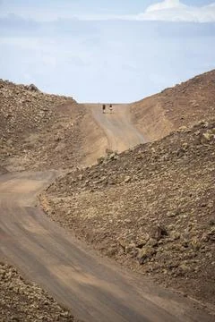 View of a two persons walking across Timanfaya National Park in Lanzarote, Ca Stock Photos