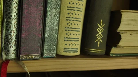 A view of two rows of very old books in the bookcase. Vintage books in a shelves Video stock 300230364