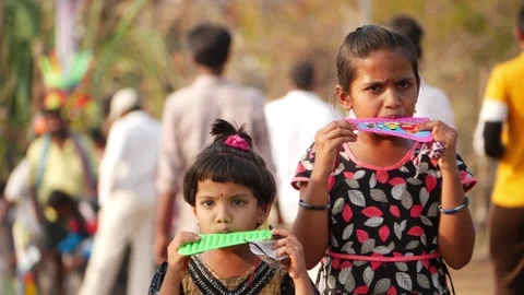 View of two small girls playing with toys on road Stock Footage 150737232