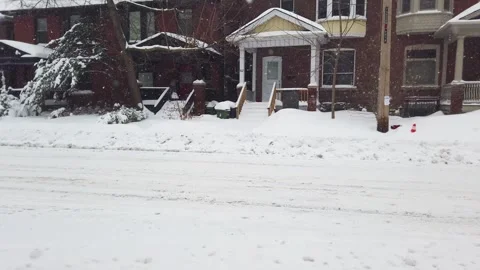 View of two-story brick private houses and deserted street  during a snowfall. Stock Footage 302563842