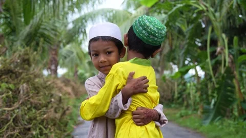 View of two young boys hugging in traditional attire, Bangladesh. 스톡 동영상 334991965