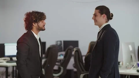 View of two young businessmen shaking hands. Businessmen shake hands after Video stock 236142655