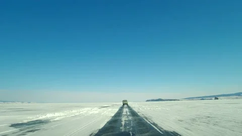 View of the UAZ car through the windshield. Driving on an icy roadway on frozen Video stock 167929611