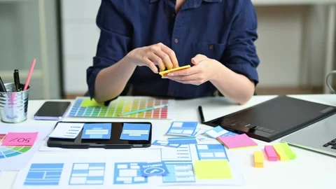 View of UI developer team brainstorming on their project with laptop, smart.. Stock Footage 312849371