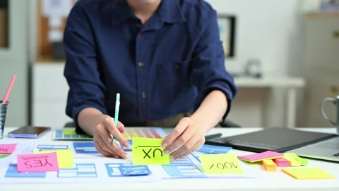 View of UI developer team brainstorming on their project with laptop, smart.. Stock Footage 312849382