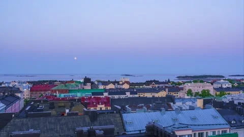 View of Ullanlinna rooftops and moon over Gulf of Finland, Finland. Timelapse. Video stock 344406603