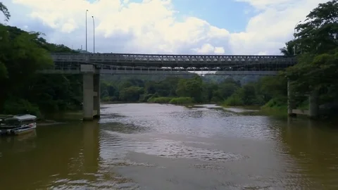 View under the bridge above river show up lush jungle Sri Lanka drone footade Stock Footage 85098259
