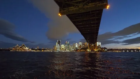 View under the Harbour Bridge and city skyline at night Stock Footage 103428881