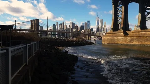 View under massive pillars of the Manhattan Bridge connecting NYC &amp; Brooklyn Stock Footage 122549875