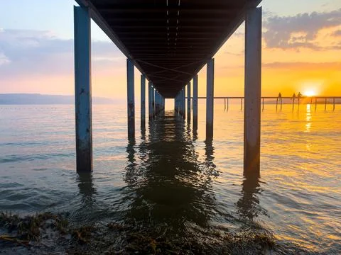 View from under the pier at the seaside, sequential view of the pier legs a.. Stock Photos