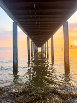 View from under the pier at the seaside, sequential view of the pier legs a.. Stock Photos