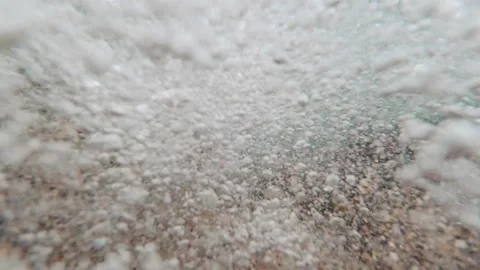 A view under water during a wave, many bubbles and sand, close-up Stock Footage 143268737