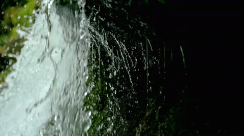 View under waterfall splash on stones in forest among mountains. Stock Footage 65492220