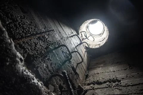 View from the underground communication to the surface through the manhole. E Stock Photos