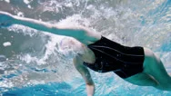 View From Underneath Of A Professional Female Swimmer Underwater Stock Footage